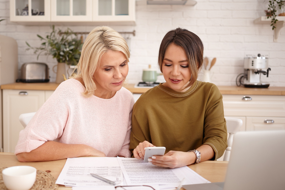 Mom and daughter setting up budget for car