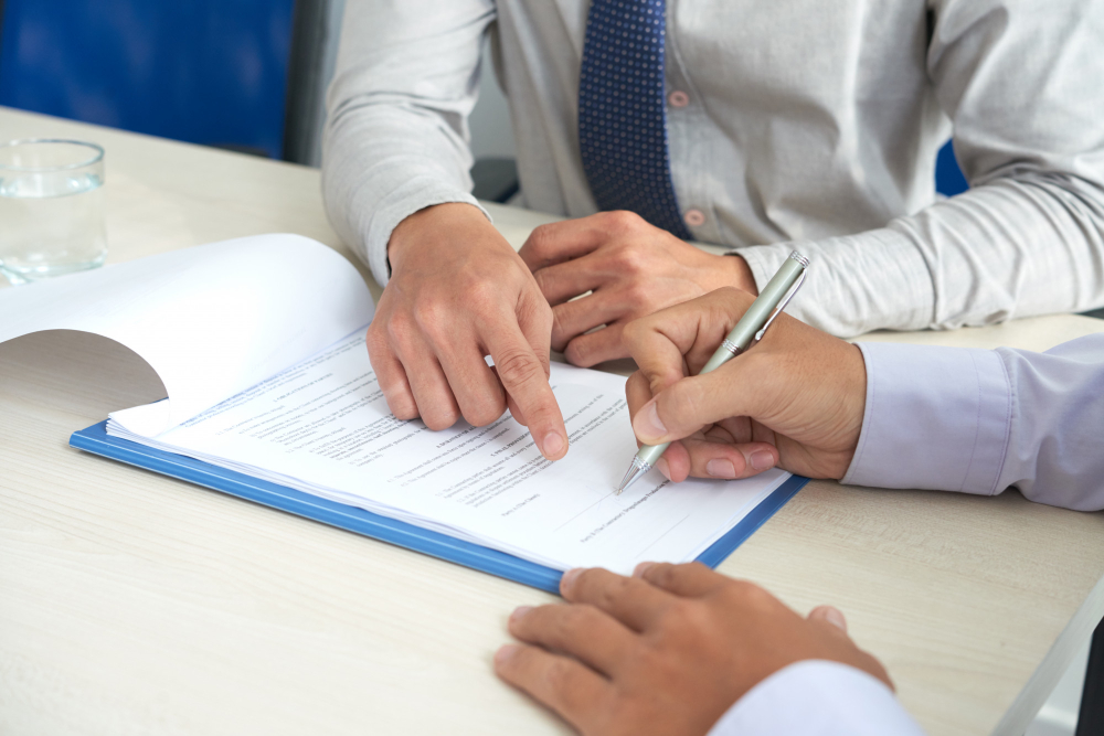 A man signing a car finance deal.