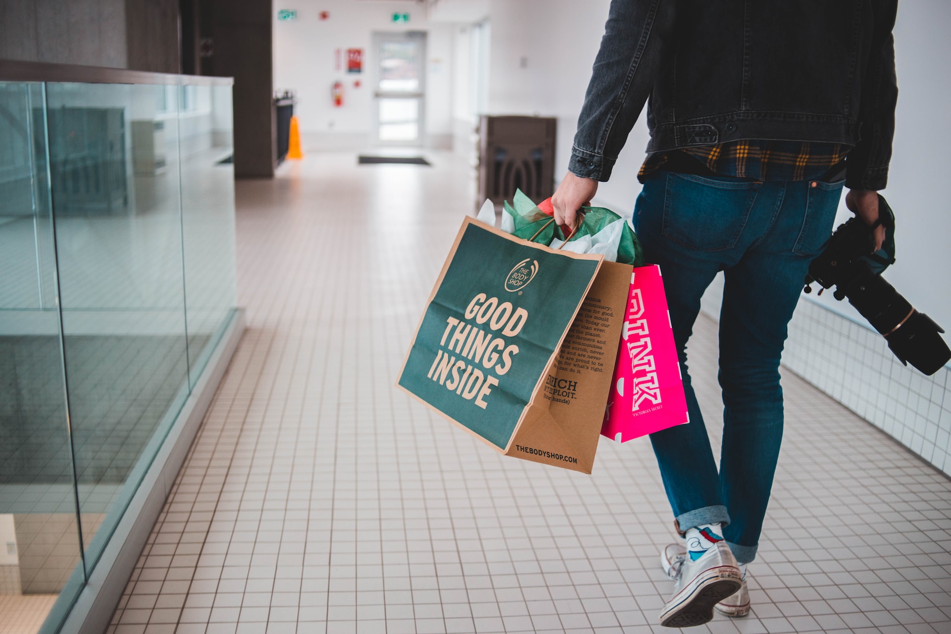 luxury spending BNPL shopper walking with shopping bags